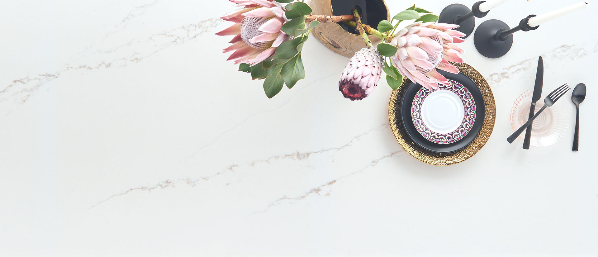 plates and vase with flowers on calacatta arno slab