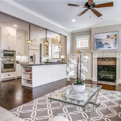 Dark soap stone with white kitchen cabinets, white large cast iron farm sink