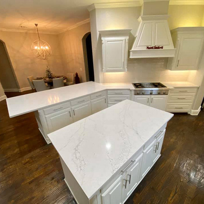 large kitchen with white cabinets and white quartz countertops