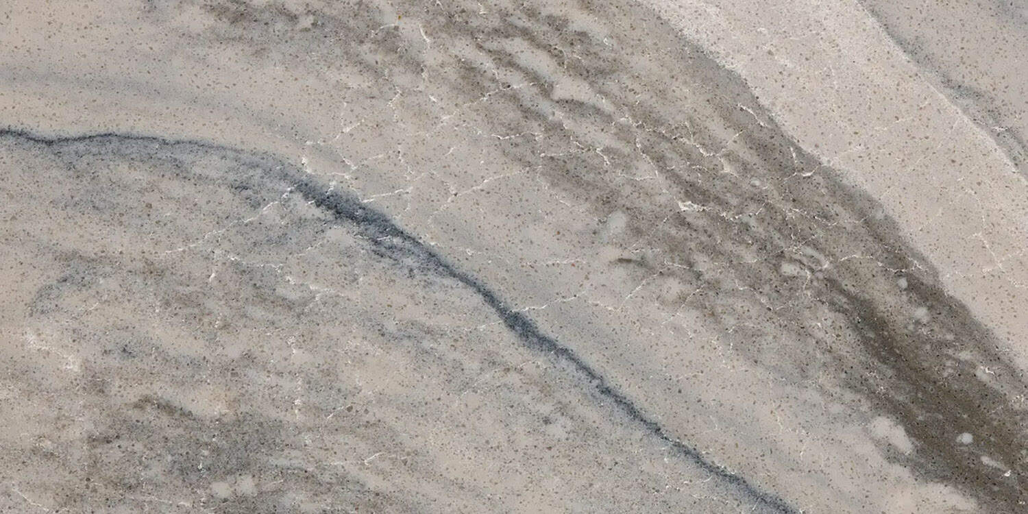 Close-up of a marble-like quartz surface with gray and beige colors