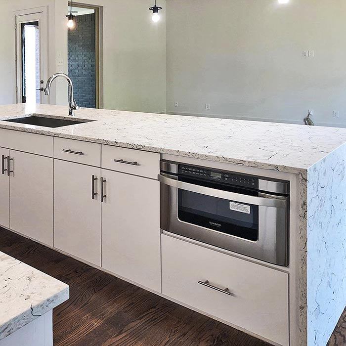 waterfall island with white cabinets