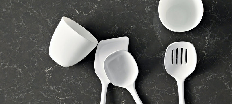 white cups and spoons on piatra grey countertops