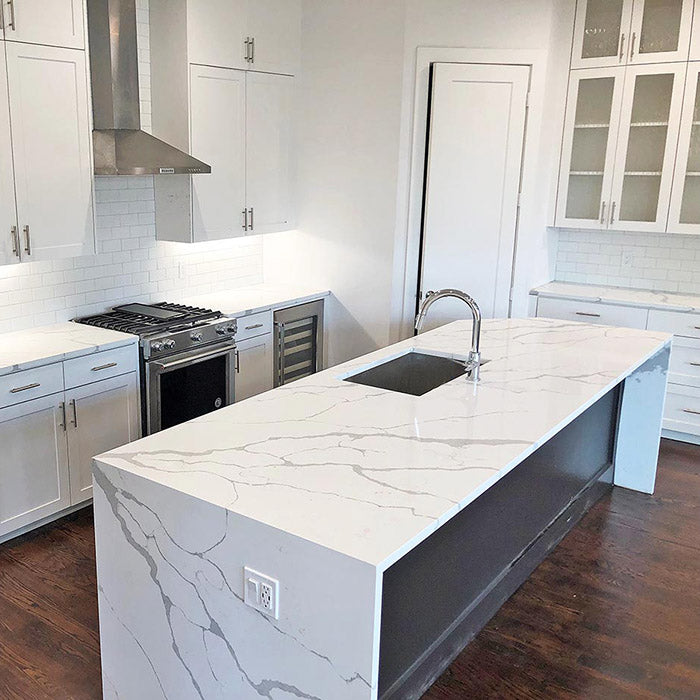 calacatta sponda quartz waterfall kitchen island with stainless steel modern sink