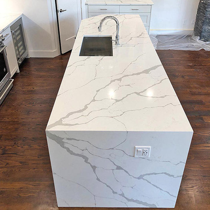 calacatta sponda quartz waterfall kitchen island with stainless steel modern sink