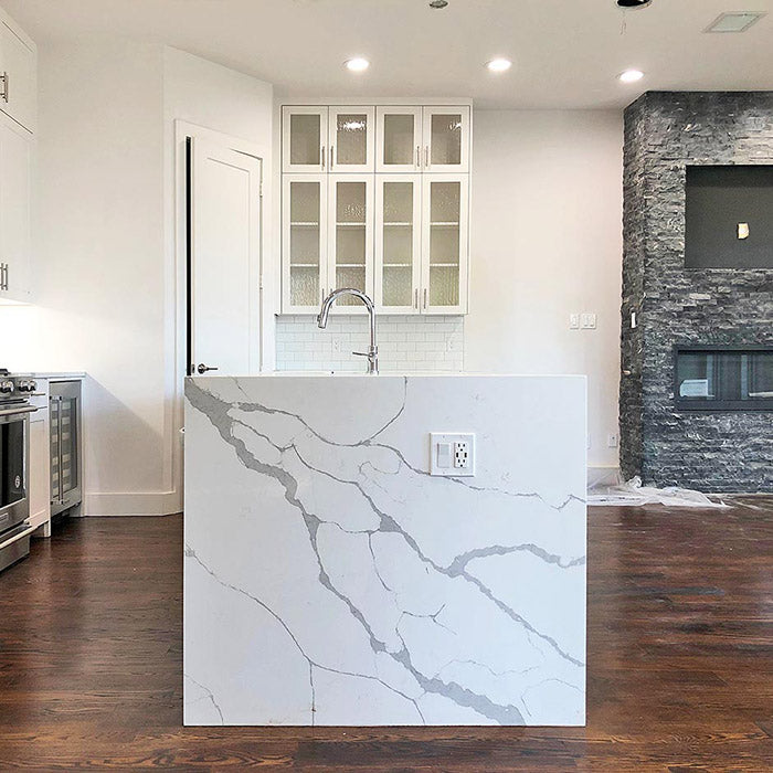 calacatta sponda quartz waterfall kitchen island with stainless steel modern sink