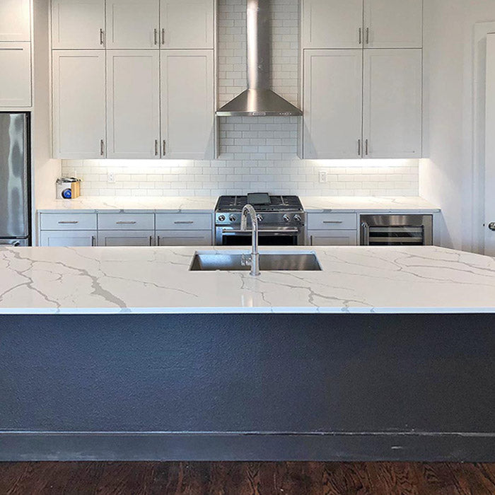 calacatta sponda quartz waterfall kitchen island with stainless steel modern sink