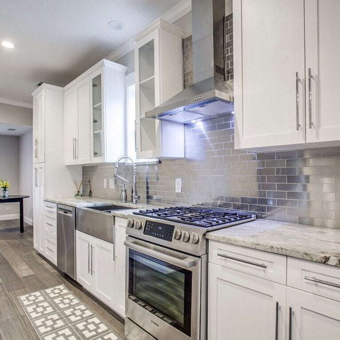 hite kitchen cabinets with fantasy brown granite countertops and stainless steel farm sink, aluminum backsplash subway tile