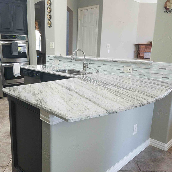 dark grey cabinets with light green grey river white granite countertops and stainless steel sink