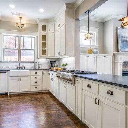Dark soap stone with white kitchen cabinets, white large cast iron farm sink